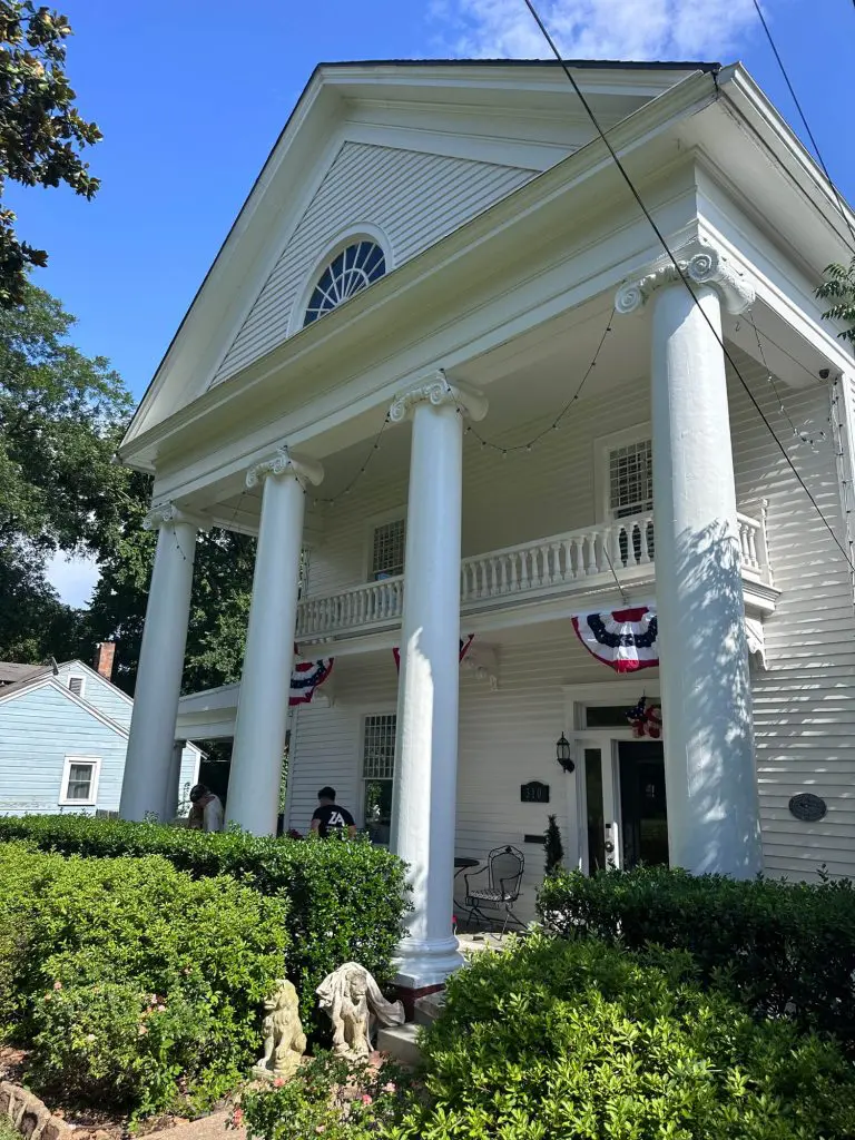 Expert exterior painting on a large, stately white historic residential home, highlighting the massive columns and detailed architecture in the Tyler, TX area.