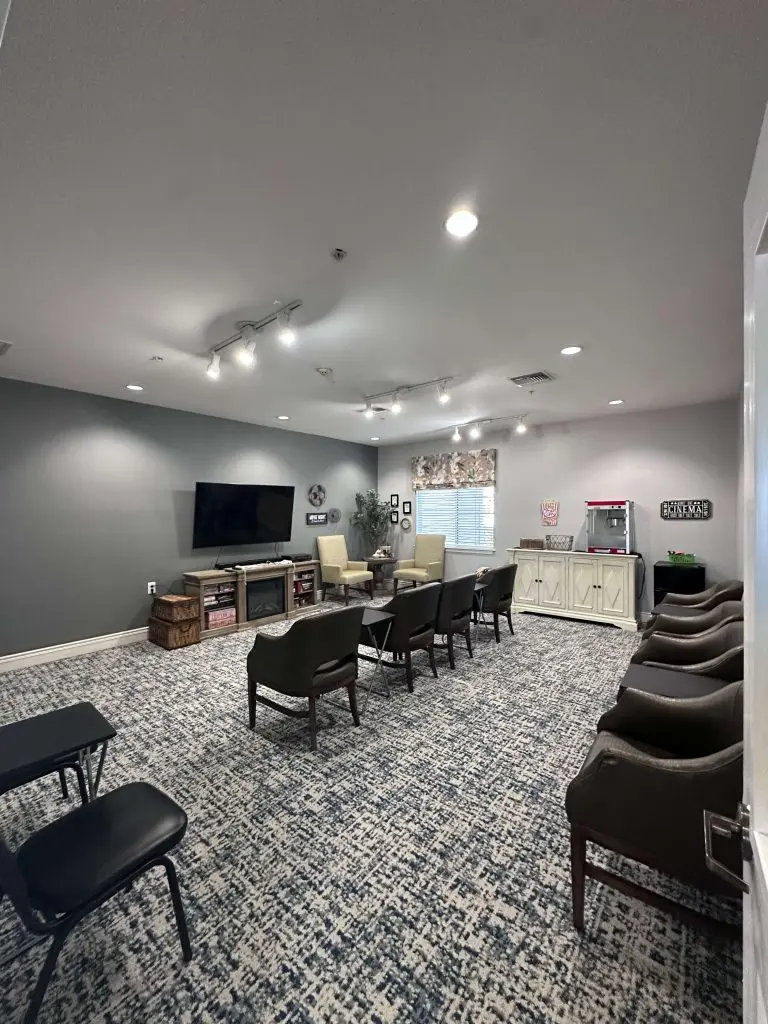 Professional commercial interior painting completed in a modern media room or common area with neutral gray walls and white trim.