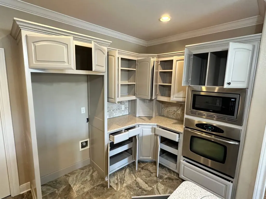 professional kitchen cabinet refinishing detail showcasing a smooth light gray paint finish on cabinet doors and drawers.