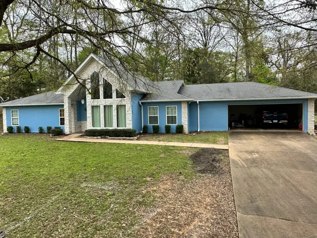 Freshly painted blue home completed by painters in Flint, TX, showing a clean exterior makeover and updated curb appeal.
