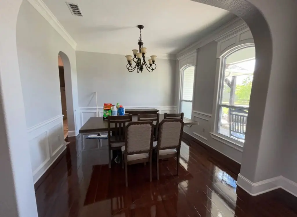 High-detail dining room interior painting featuring custom white wainscoting, arched trim work, and modern gray walls by Z&A Custom Painting.