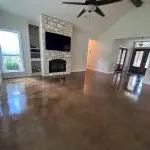 High-end interior painting of a bright vaulted living room with white walls, stone fireplace, and crisp white trim by Z&A Custom Painting.