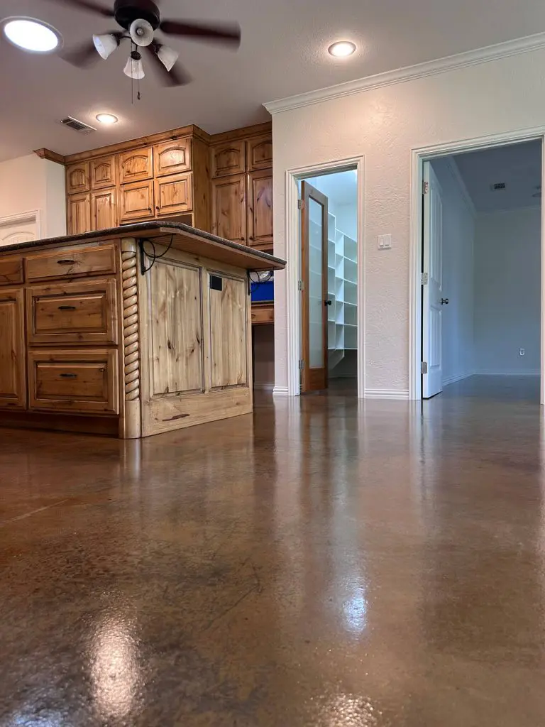 High-quality kitchen interior painting with crisp white trim and pine cabinets, highlighting Z&A Custom Painting's Cabinet Refinishing service.